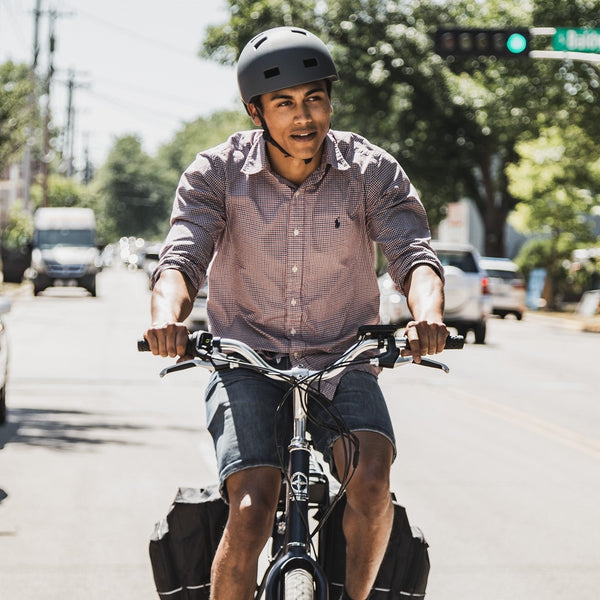 A guy riding his e-bike to save money on gas.